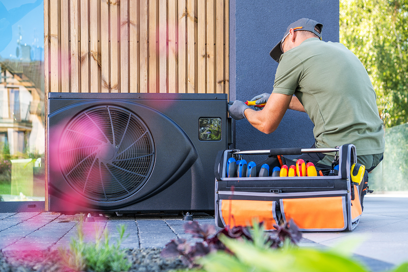 Technician installing an air conditioning unit